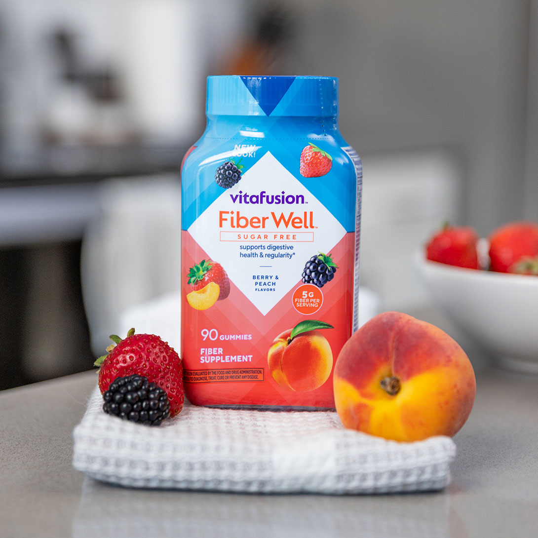 Woman dancing happily in a bright modern kitchen – Fiber Well® lifestyle